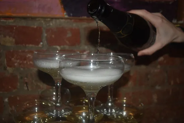 Champagne poured into the top glass of the tower