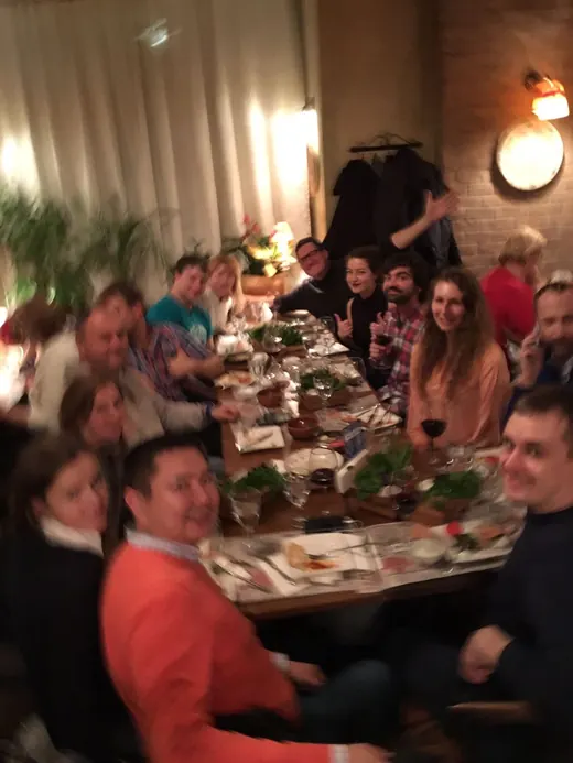 A long table crowded with people and food