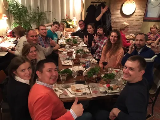 A long table of people smiling at the camera