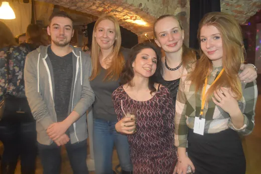 Five people posing together, smiling