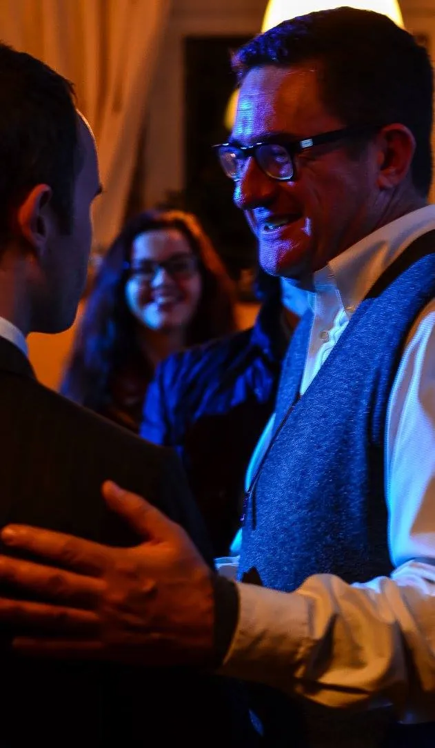 A woman laughing in the middle of a conversation, blue light