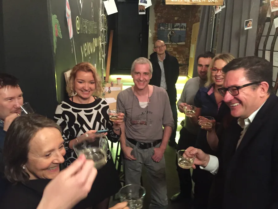 Glasses raised at the bar, everyone toasting