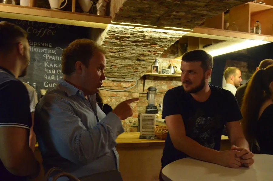 A man pointing across the bar, making his case