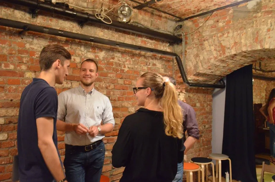 A man in a white shirt explaining something with his hands