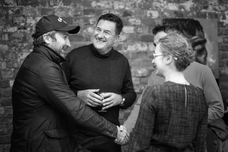 Three friends laughing together, in black and white