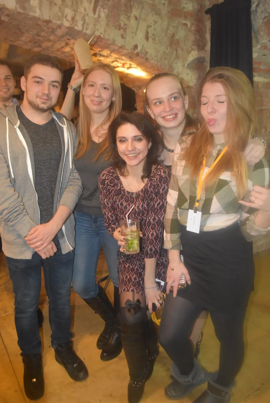 Five friends with drinks and name badges