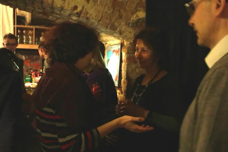 Two women in a quiet conversation in the gallery