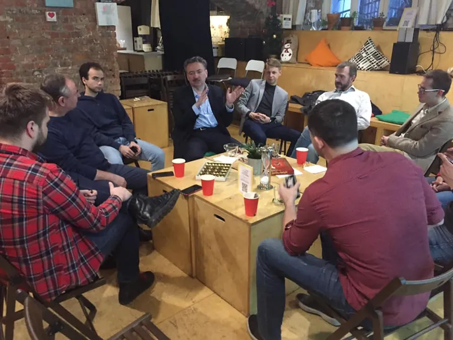 A group around the low table with cups